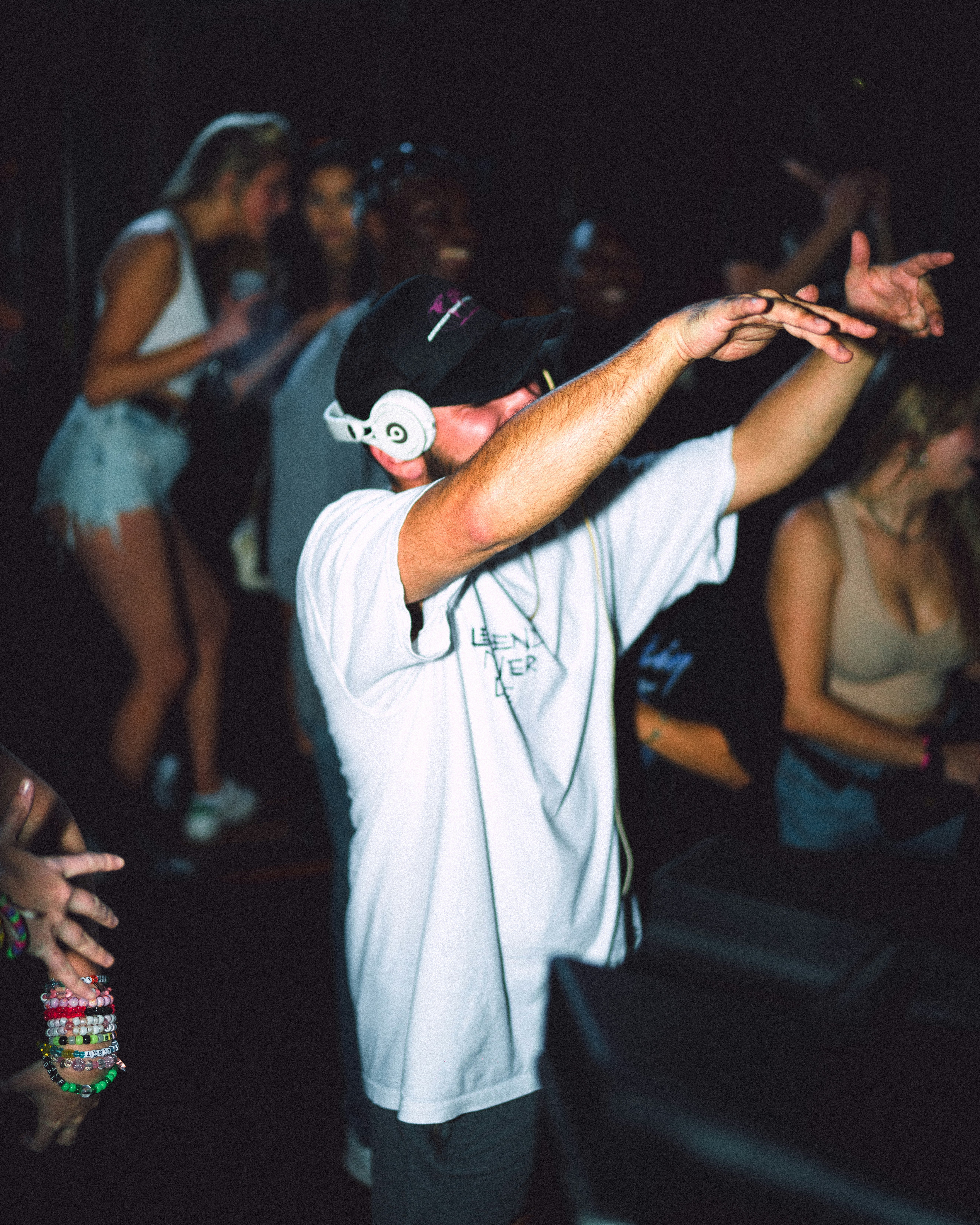 man in white t-shirt holding white ball